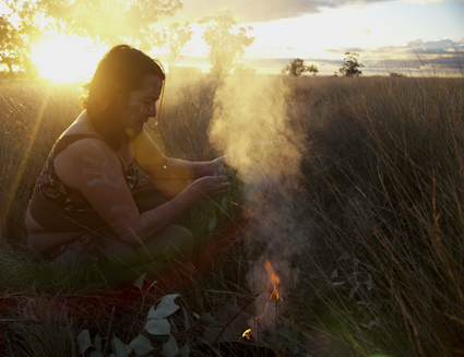 Lily Shearer leading a smoking ceremony at the posts