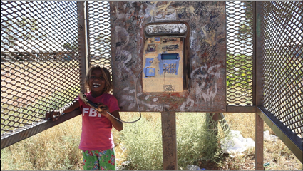 Masey Robinson at the Parnngurr phone booth, The Phone Booth Project, 2012, Lily Hibberd and Curtis Taylor, We Don't Need a Map