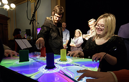 Founding Amplified Elephants member Kathryn Sutherland demonstrates the RESONANCE table for the audience after the concert